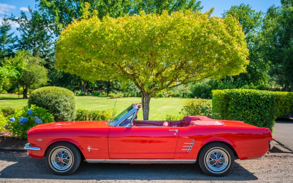 Red vintage convertible Ford Mustang.