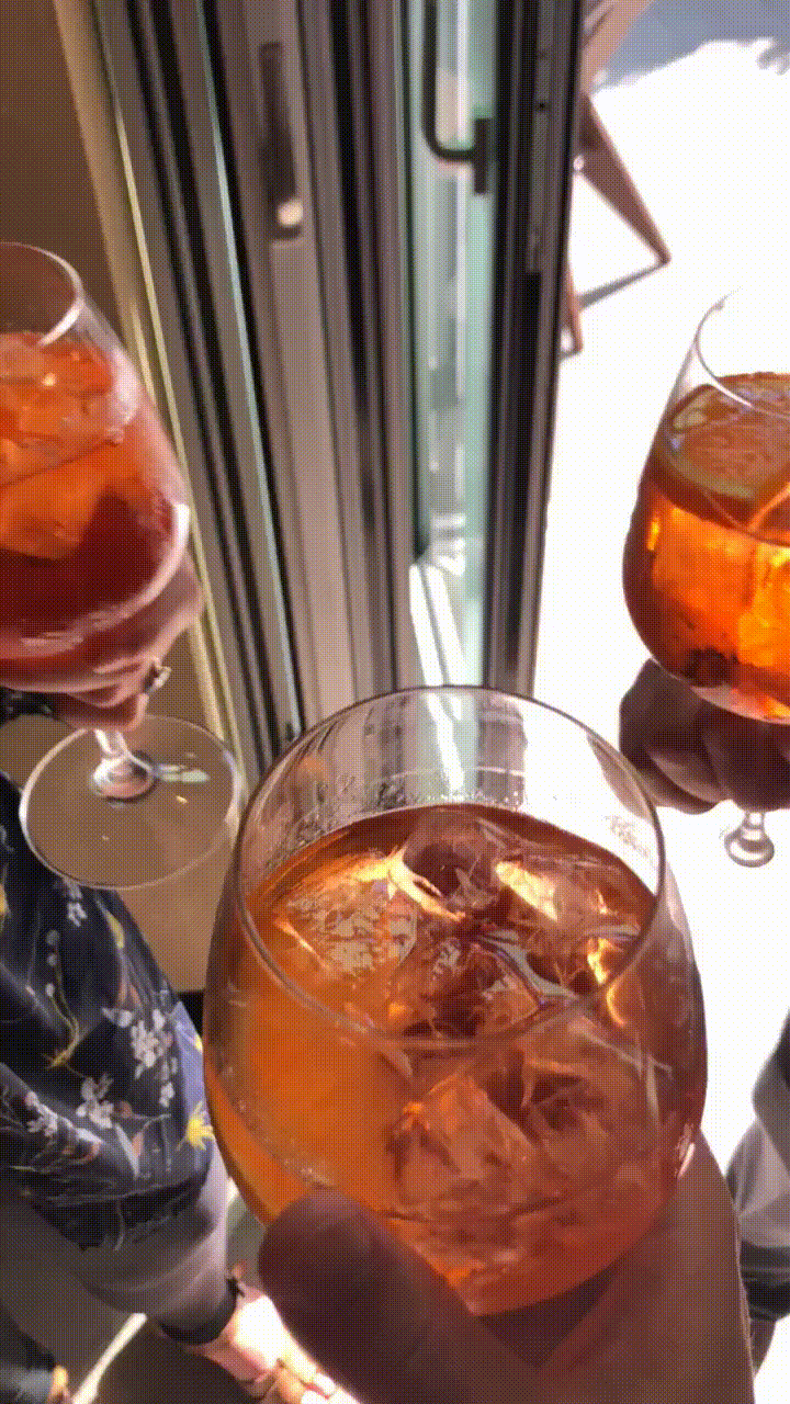 Friends having a toast with aperol spritz.